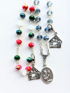 A close up of the St Andrew Novena Chaplet with the christmas colora on the left and the blue on the right. 