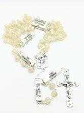 Load image into Gallery viewer, A pearl glass bead mysteries rosary lays on a white background