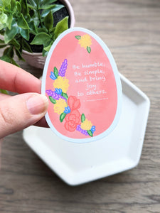 A hand hold the easter egg shaped sticker.