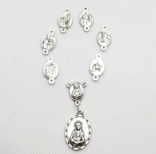 Load image into Gallery viewer, The medals featured on this chaplet depic the scenes of the sorrows of Mary. The medals are arranged in an oval or rosary shape and are laying on a white background 