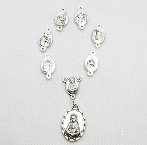 The medals featured on this chaplet depic the scenes of the sorrows of Mary. The medals are arranged in an oval or rosary shape and are laying on a white background 