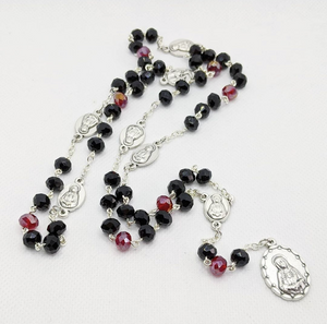 A black and red 7 sorrows of Mary chaplet sets on a white background